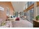 Comfortable sunroom featuring brick floors, neutral furniture, and sliding glass doors at 6551 Forrest Commons Blvd, Indianapolis, IN 46277