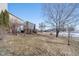 Landscaped backyard with deck and mature trees at 7541 Mather Ln, Indianapolis, IN 46239