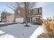 Two-story brick home with attached garage, landscaping, and snow on the ground at 7541 Mather Ln, Indianapolis, IN 46239