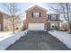 Two-story brick home with attached garage and snow-covered driveway at 7541 Mather Ln, Indianapolis, IN 46239