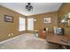 Bright home office features a large desk, window, and ceiling fan at 7541 Mather Ln, Indianapolis, IN 46239