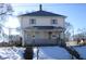 Two-story duplex with front porch and snowy yard at 831 W 27Th St, Indianapolis, IN 46208