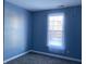 Simple bedroom with gray carpet and a window with sheer curtains at 952 Rentham Ln, Indianapolis, IN 46217