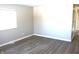 Spacious living room featuring grey laminate flooring and neutral walls at 9903 E 17Th St, Indianapolis, IN 46229