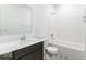 Modern bathroom features a white vanity with a dark wood cabinet and a shower-tub combo at 1020 Stonehaven Dr, Indianapolis, IN 46239