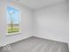 Bright bedroom features a window with a picturesque outdoor view and neutral carpeting at 1020 Stonehaven Dr, Indianapolis, IN 46239