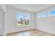 Bright bedroom with light hardwood floors and large windows, offering scenic views and ample natural light at 1020 Stonehaven Dr, Indianapolis, IN 46239
