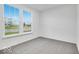Sun-filled bedroom with a view through the double windows and plush neutral carpeting at 1020 Stonehaven Dr, Indianapolis, IN 46239