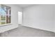 Bright bedroom with neutral carpet and a large window overlooking a view at 1020 Stonehaven Dr, Indianapolis, IN 46239