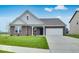 Charming brick home featuring a well-manicured lawn, attached two car garage, and stylish architectural details at 1020 Stonehaven Dr, Indianapolis, IN 46239