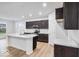 Modern kitchen featuring dark cabinets, stainless steel appliances, and a bright white island at 1020 Stonehaven Dr, Indianapolis, IN 46239