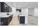 Bright kitchen featuring dark cabinets, stainless steel appliances, and a bright white island at 1020 Stonehaven Dr, Indianapolis, IN 46239