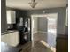 Kitchen features white cabinets, black appliances, and wood floors at 1097 S 5Th St, Noblesville, IN 46060