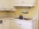 Vintage kitchen with white cabinets, yellow walls, and a gas cooktop at , Indianapolis, IN 46227