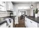 View of kitchen leading to dining room, featuring white cabinets and stainless steel appliances at 1206 Comer Ave, Indianapolis, IN 46203