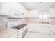 White kitchen with pink countertops and built-in microwave at 1217 Charleston Commons Dr # 25, Anderson, IN 46012