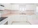 White kitchen with pink countertops and double sink at 1217 Charleston Commons Dr # 25, Anderson, IN 46012