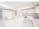 Efficient kitchen with white cabinets, pink countertops, and built-in desk at 1217 Charleston Commons Dr # 25, Anderson, IN 46012