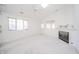 Living room features fireplace, ceiling fan, and multiple windows at 1217 Charleston Commons Dr # 25, Anderson, IN 46012