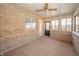 Sunroom offering brick walls, carpet floor, and multiple windows at 1217 Charleston Commons Dr # 25, Anderson, IN 46012