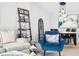 Inviting living room with a stylish accent chair, decorative shelving, and a modern light fixture over the dining table at 12584 Tennyson Ln # 208, Carmel, IN 46032