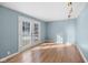 Sunlit dining room featuring hardwood floors and French doors at 1407 Mar Lee Ln, Lebanon, IN 46052