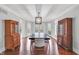 Elegant dining room with hardwood floors, a modern chandelier, and views to the patio at 14519 Cherry Tree Rd, Carmel, IN 46033