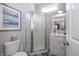 Small bathroom with corner shower, vanity, and framed art at 1525 S New Jersey St, Indianapolis, IN 46225