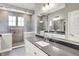 Beautiful bathroom featuring a large mirror, vanity with a gray countertop, and tiled walk-in shower with two windows at 16258 Perrault Ct, Fishers, IN 46040