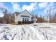 Two story new construction house with neutral siding, dark brick foundation, and a fresh coating of snow at 16258 Perrault Ct, Fishers, IN 46040