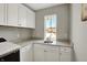 Laundry room features a window and light granite countertops with ample cabinet space at 16258 Perrault Ct, Fishers, IN 46040