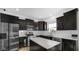 Modern kitchen features dark cabinetry, stainless steel appliances, and a large island at 17935 Paula, Westfield, IN 46074