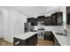Modern kitchen with dark cabinets, stainless steel appliances, and an island at 17935 Paula, Westfield, IN 46074