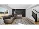 Living room with sectional sofa, accent wall, and hardwood floors at 17935 Paula, Westfield, IN 46074
