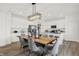 Modern dining room featuring a long wood table, gray chairs, and a stylish light fixture at 2112 Boxwood Dr, Greenfield, IN 46140