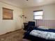 Cozy bedroom featuring a bed, desk, and window coverings at 2147 W 65Th St, Indianapolis, IN 46260