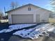 Detached garage with tan door, and snow on the ground at 2147 W 65Th St, Indianapolis, IN 46260