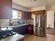 Kitchen with stainless steel appliances and wood cabinets at 2147 W 65Th St, Indianapolis, IN 46260