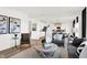 Open concept living space with gray sectional and views into the kitchen and dining area at 2765 Linwood Ave, Greenwood, IN 46143