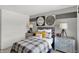 Serene bedroom featuring gray walls and a gray plaid comforter at 3872 Branch Cir, Franklin, IN 46131