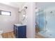 Modern bathroom with blue vanity and glass shower at 404 N State St, Greenfield, IN 46140