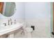 Modern bathroom with white pedestal sink, toilet, and marble-tiled shower at 404 N State St, Greenfield, IN 46140