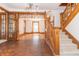 Entryway with hardwood floors, staircase, and wood accents at 404 N State St, Greenfield, IN 46140