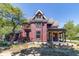 Side view of the charming red Victorian house, showcasing its architectural details at 404 N State St, Greenfield, IN 46140