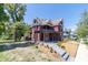 Beautiful red Victorian home with wrap-around porch and landscaped yard at 404 N State St, Greenfield, IN 46140