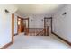 Upper hallway with hardwood floors, ornate woodwork, and a staircase at 404 N State St, Greenfield, IN 46140