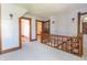 Upper hallway with hardwood floors, ornate woodwork, and a staircase at 404 N State St, Greenfield, IN 46140