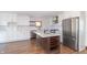 Remodeled kitchen with white cabinets, stainless steel appliances, and kitchen island at 404 N State St, Greenfield, IN 46140