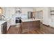 Remodeled kitchen with white cabinets, stainless steel appliances, and kitchen island at 404 N State St, Greenfield, IN 46140