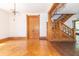 Elegant living area with hardwood floors and grand staircase at 404 N State St, Greenfield, IN 46140
